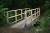 Simple Oak Bridge across Stream